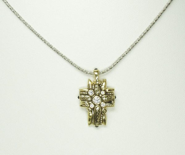Alex Sepkus, 18kt 'Cross' bezel set with Diamonds, and cabochon Sapphires.